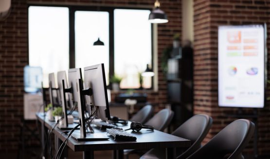 No people in office with multiple computers at customer service desk, call center helpline support to give telecommunication assistance. Empty helpdesk with client telephony reception.